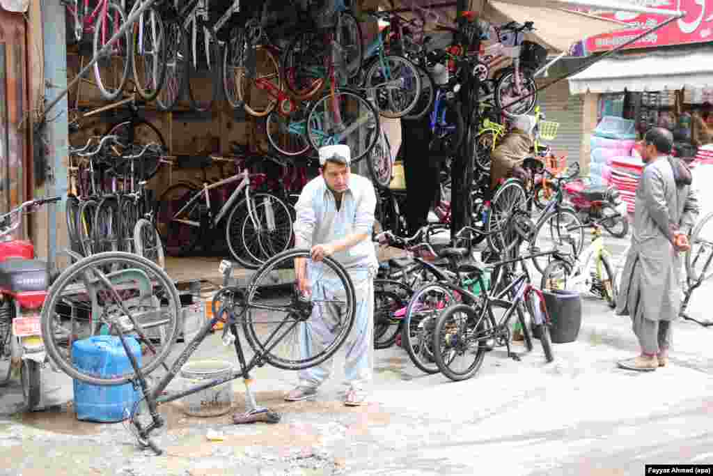 A man repairs a bicycle at a shop in Quetta, Pakistan, on April 7 as commuters look for ways to avoid motorcycles amid a surge in fuel prices.