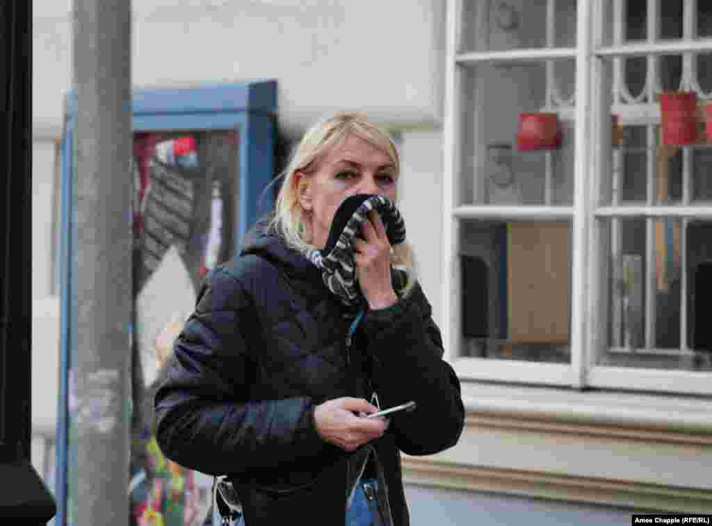 A woman breathing through her scarf in Prague&#39;s Mala Strana area.&nbsp;