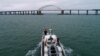 A Russian patrol boat approaches the Kerch Strait Bridge.