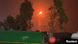 A gas flare burns at the Lanaz refinery after it was targeted by a drone strike in Irbil, northern Iraq.
