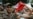 Security personnel detain a member of All India Youth Federation (AIYF) during a protest demanding the resignation of India's Chief Election Commissioner Gyanesh Kumar over alleged voter roll irregularities linked to the "special intensive revision" (SIR)