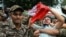 Security personnel detain a member of All India Youth Federation (AIYF) during a protest demanding the resignation of India's Chief Election Commissioner Gyanesh Kumar over alleged voter roll irregularities linked to the "special intensive revision" (SIR)