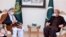 Karim Khalili (left), an influential Afghan Shi'ite leader, meets with Pakistani Foreign Minister Shah Mahmood Qureshi at the Foreign Ministry in Islamabad on January 12.