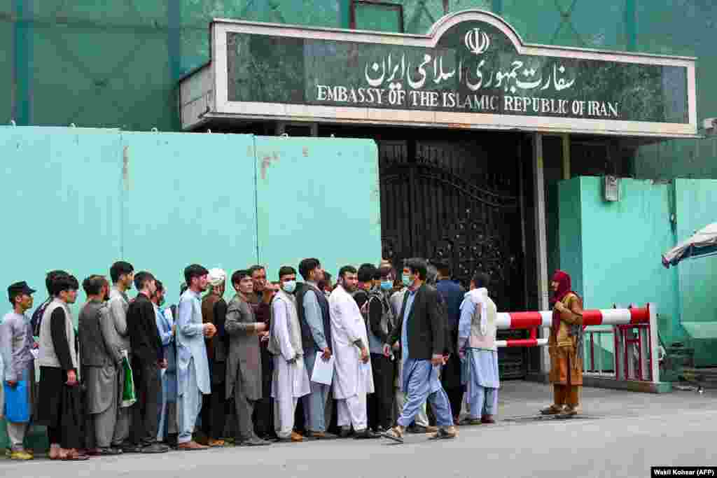 Afghans line up to apply for visas outside the Iranian Embassy in Kabul on August 17.