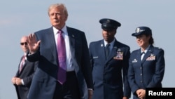 US President Trump disembarks Air Force One at Ellington Field Joint Reserve Base in Houston on August 27.