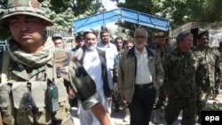 Abdul Jabar Taqwa (center, in white shirt and black trousers), the governor of Takhar Province, seen on a district visit in June 2010