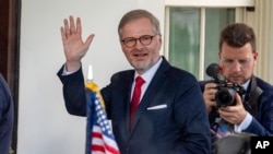 Czech Prime Minister Petr Fiala waves as he arrives for a meeting with U.S. President Joe Biden at the White House on April 15.