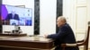 Pe candidatul Putin, încheierea înscrierii în cursa pentru „prezidențiale” l-a prins când se adresa prin video unei conferințe pe teme economice. În poza cea mai mare de pe ecran: premierul Mihail Mișustin. 