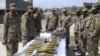 Pakistani Army soldiers show arms and ammunition recovered during operations against Taliban militants 