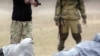 A capture from the Islamic State video purporting to show the execution of what it describes as two Russian spies.