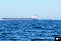 Oil tankers sail off the coast of Kuwait City on June 27.