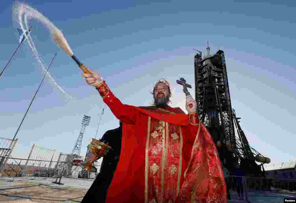 An Orthodox priest conducts a blessing in front of a Soyuz MS-04 spacecraft ahead of its upcoming launch at the Baikonur Cosmodrome in Kazakhstan. (Reuters/Shamil Zhumatov)