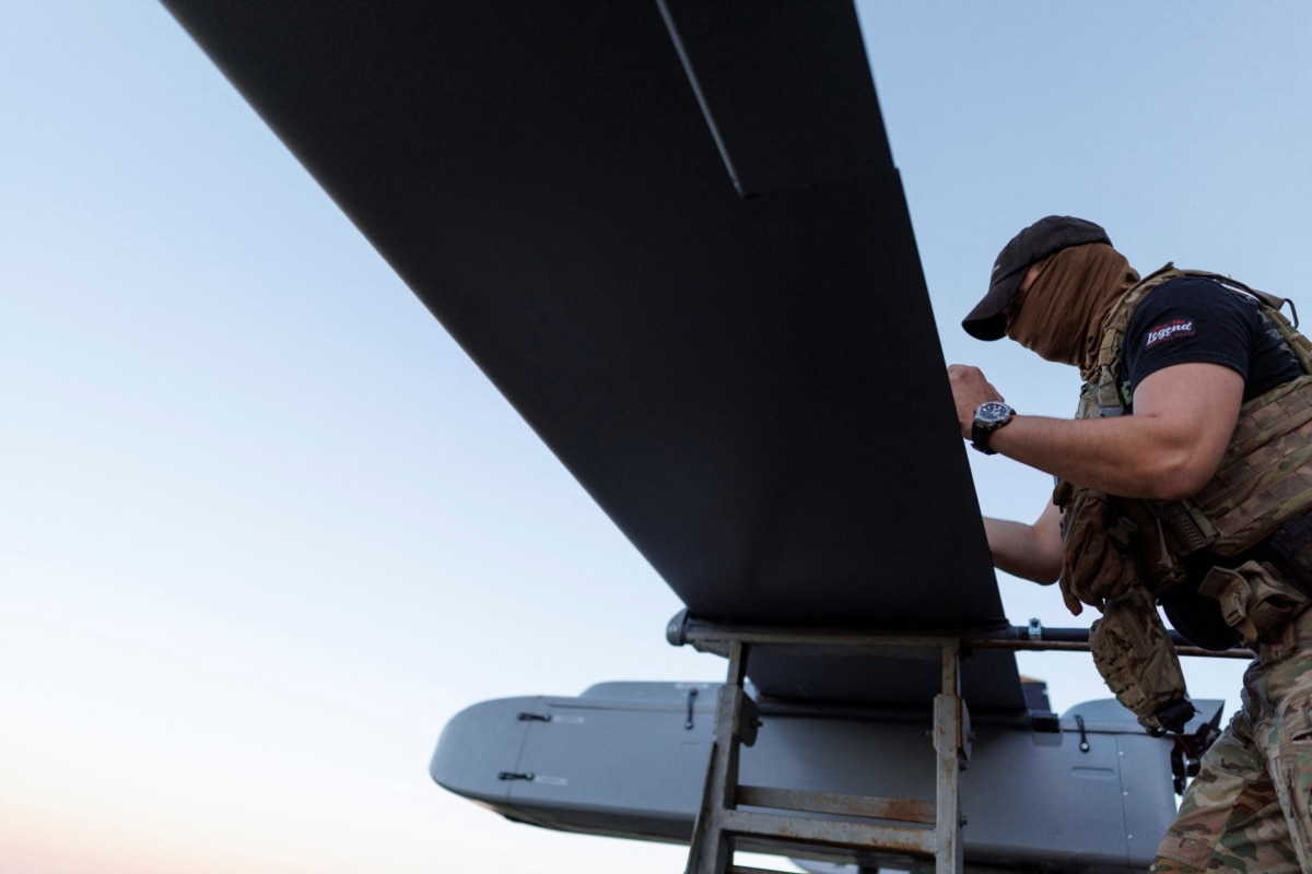 A serviceman of the Ukrainian Armed Forces' 414th Separate Unmanned Systems Strike Brigade 'Birds of Magyar' writes a message to Russians on an FP-1 drone before launch, at an undisclosed location in Ukraine, 2026