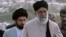 Mojtaba Khamenei (left) walks behind his father, Supreme Leader Ayatollah Ali Khamenei. (file photo)