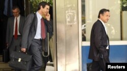 IMF and EU officials leave the Greek Finance Ministry amid talks on a bailout deal.