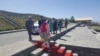 Malala Yousafzia (center, in red) arrives with her family during a visit to Mingora on March 31.