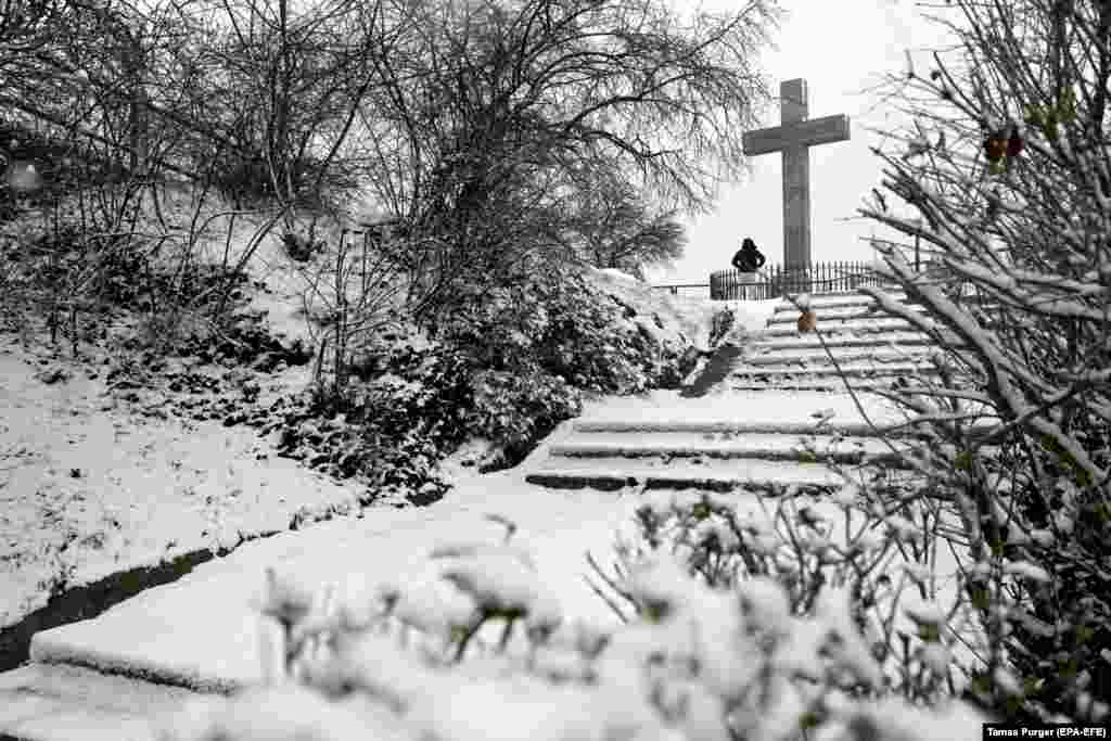 A person stands at a sight-seeing point covered in fresh snow on Gellert Hill in Budapest, Hungary.&nbsp;