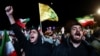 People shout slogans as they gather in Tehran on April 8 after a two-week cease-fire between the US and Iran was announced.