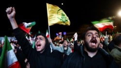 People shout slogans as they gather in Tehran on April 8 after a two-week cease-fire between the US and Iran was announced.