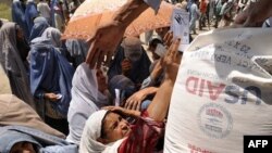 Afghan women receive food donations from the World Food Program