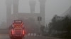 A bus travels the streets of Lahore on November 16 amid the city's air-quality crisis.