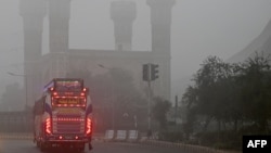 A bus travels the streets of Lahore on November 16 amid the city's air-quality crisis.