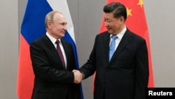 Chinese leader Xi Jinping (right, with Russian President Vladimir Putin) called the U.S.S.R.'s dissolution “a profound lesson” that many China watchers say has helped fuel Beijing’s tough crackdowns and desire for control over varying aspects of life.