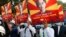 BURMA -- MYANMAR -- Engineers hold posters with an image of deposed Myanmar leader Aung San Suu Kyi as they hold an anti-coup protest march in Mandalay, Myanmar Monday, Feb. 15, 2021.