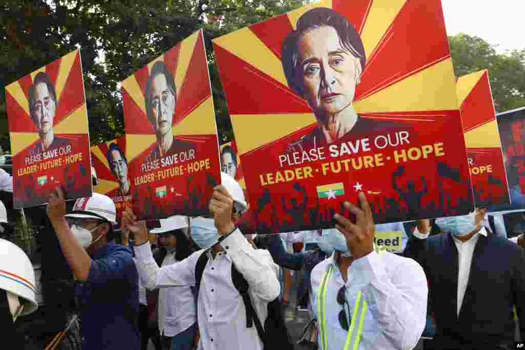 BURMA -- MYANMAR -- Engineers hold posters with an image of deposed Myanmar leader Aung San Suu Kyi as they hold an anti-coup protest march in Mandalay, Myanmar Monday, Feb. 15, 2021. 