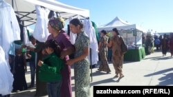 Turkmenistan. Mother of two trying to make school shopping for her children in Ashgabat.
