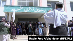 A group of Taliban fighters pose for a photo in the Zarghoo Shahr high school.