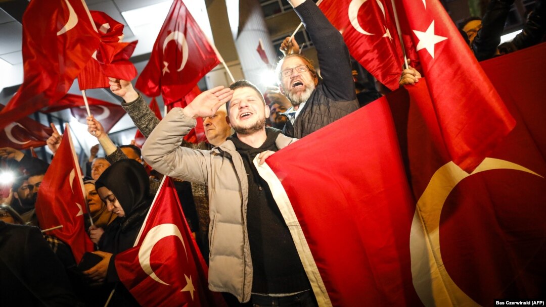 Dutch Turkish demonstrators hold Turkish flags as they gather outside the Turkish Consulate in Rotterdam on March 11 after the Netherlands refused Turkish Foreign Minister Mevlut Cavusoglu permission to land for a rally to gather support for a referendum on boosting the Turkish president's powers.