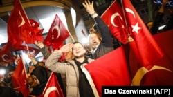 Demonstrators hold Turkish flags as they gather outside the Turkish Consulate in Rotterdam, on March 11 after the Netherlands refused Turkish Foreign Minister Mevlut Cavusoglu permission to land for a rally. 