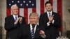 U.S. -- Vice President Mike Pence (L) and Speaker of the House Paul Ryan (R) applaud as US President Donald J. Trump (C) arrives to deliver his first address to a joint session of Congress from the floor of the House of Representatives in Washington, Fe