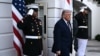 US President Donald Trump stands at an entrance to the White House in Washington on April 13.