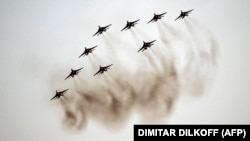 Russian Air Force aerobatic teams in MiG-29 and Su-27 jets perform during an air show during the 2021 International Aviation and Space Salon in Zhukovsky, outside Moscow, in July 2021.