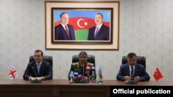 Azerbaijan - Defense Ministers Irakli Alasania (L) of Georgia, Zakir Hasanov (C) of Azerbaijan and Ismet Yilmaz of Turkey address the press after talks in Nakhichevan, 19Aug2014.