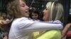 Armenia - A newly arrived Syrian Armenian woman (L) is greeted by a relative at Yerevan's Zvartnots airport, 30Jul2012.