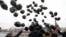 Russian opposition activists and human rights defenders release black balloons in front of the Kremlin to mark the sixth anniversary of the death in prison of lawyer Sergei Magnitsky in Moscow on November 16, 2015.