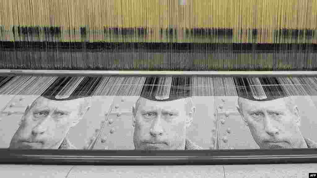 An automatic loom produces tapestries with portraits of Prime Minister Vladimir Putin at a mill in the town of Vyritsa. (AFP/Valentina Svistunova)