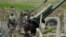 Nagorno-Karabakh -- Ethnic Armenian soldiers stand next to a cannon at artillery positions near the Nagorno-Karabakh's town of Martuni, April 7, 2016