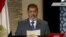 Egyptian President-elect Muhammad Morsi speaks during his first televised address to the nation in Cairo on June 24.