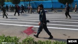 Blood can be seen on the street after gunmen opened fire on a military parade in Ahvaz.