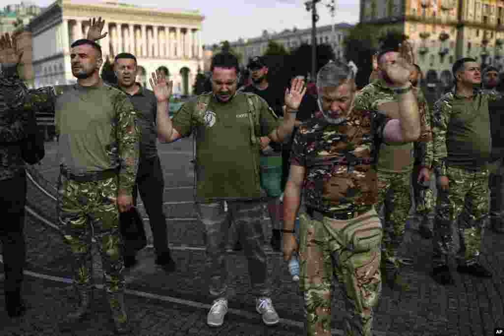 A group of Ukrainian soldiers pray during a worship service organized by a local Christian church in Kyiv.