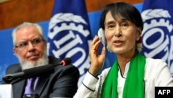 Myanmar democracy icon Aung San Suu Kyi is seen with the president of the International Labor Organization, Juan Somavia, in Geneva hours before she fell ill in Bern on June 14.