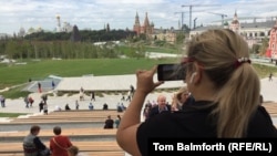 A visitor takes a photo of the view of Moscow's skyline from the new Zaryadye Park on September 15. 