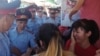 Kazakhstan - Police officers try to take out sellers, who protest demolishing their boutiques in Central Qyrgy market. Shymkent, 30July2018