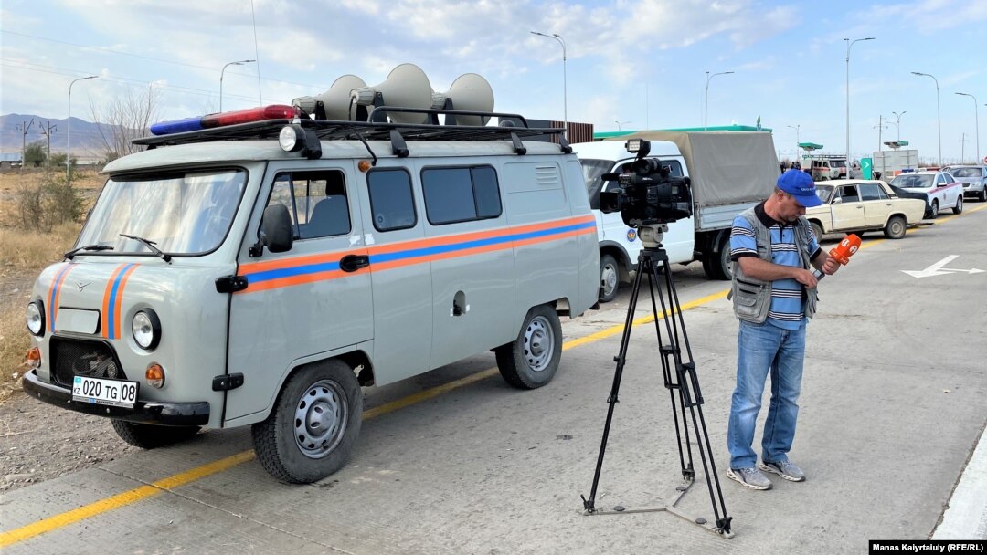 Journalists close to the site of where an explosion occurred in Kazakhstan's Baizak district on August 27.