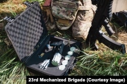 A Ptashka anti-drone gun in a case with multiple net rounds.