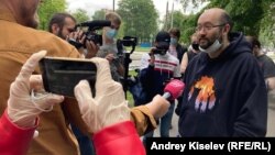 Ilya Azar (right) talks to journalists after his release.